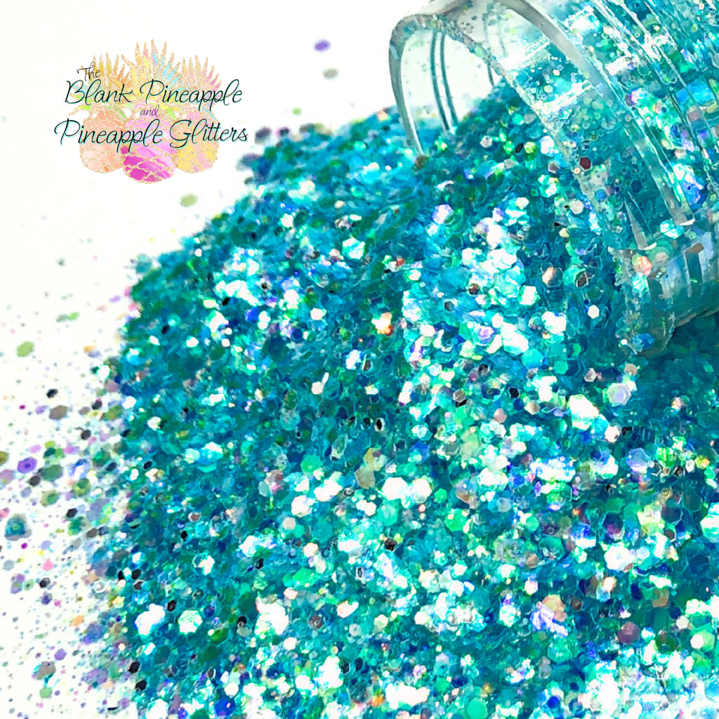 Crystal Blue iridescent mixed glitter in a 2oz shaker bottle, perfect for crafts, resin projects, and nail art. The Blank Pineapple