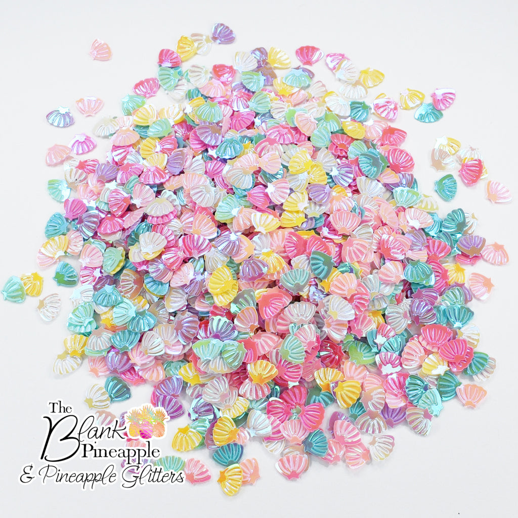 Iridescent PVC seashell-shaped confetti, 2oz bag (56g), perfect for crafts, decor, and parties with a shimmering ocean-inspired finish. - The Blank Pineapple