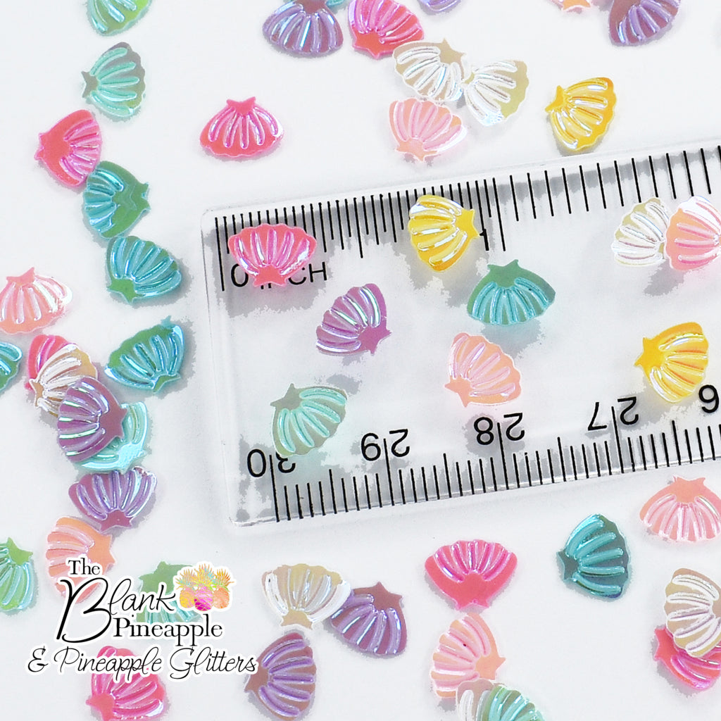 Iridescent PVC seashell-shaped confetti, 2oz bag (56g), perfect for crafts, decor, and parties with a shimmering ocean-inspired finish. - The Blank Pineapple